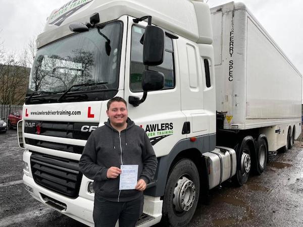Newly qualified driver holding pass certificate by HGV class 1 category c+e licence training lorry in Bradford