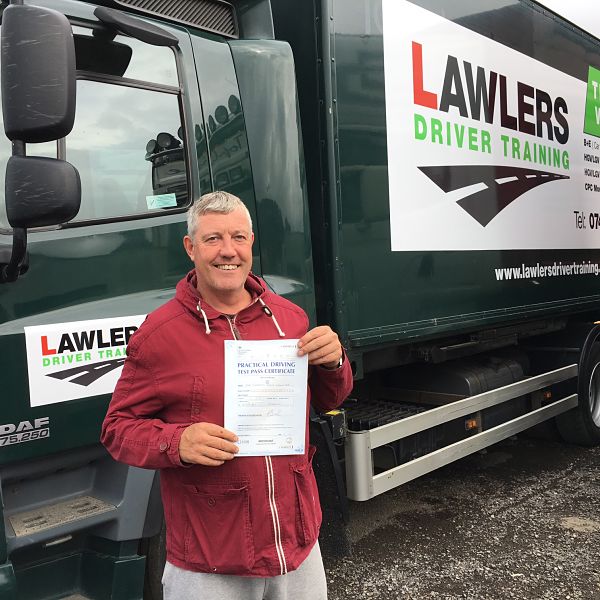 Gareth from Bradford holding pass certificate in front of HGV Class 2 category C truck